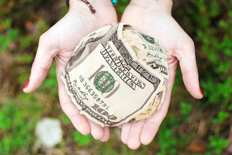 Canva person holding u.s. dollar banknotes